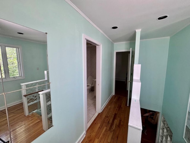 980 Siems Ct, North Bellmore, NY 11710 - corridor featuring crown molding, wood finished floors, an upstairs landing, and baseboards