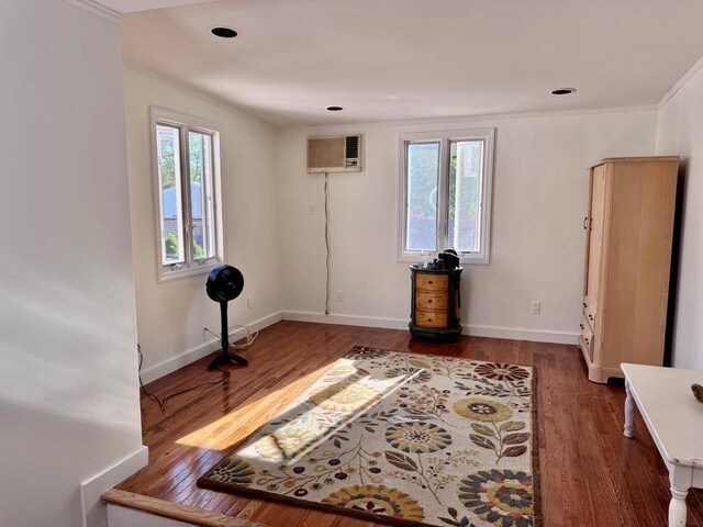 980 Siems Ct, North Bellmore, NY 11710 - spare room with wood finished floors, crown molding, an AC wall unit, baseboards, and recessed lighting