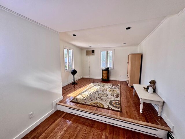 980 Siems Ct, North Bellmore, NY 11710 - living area with a wall mounted AC, wood finished floors, baseboards, and crown molding