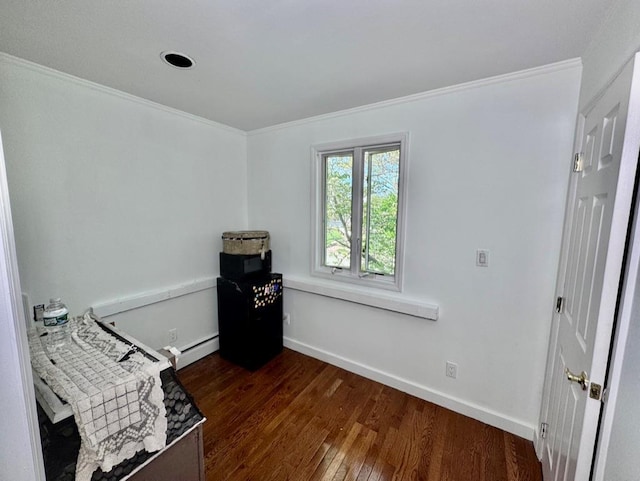 980 Siems Ct, North Bellmore, NY 11710 - bedroom featuring crown molding, dark wood-style floors, baseboards, and a baseboard heating unit