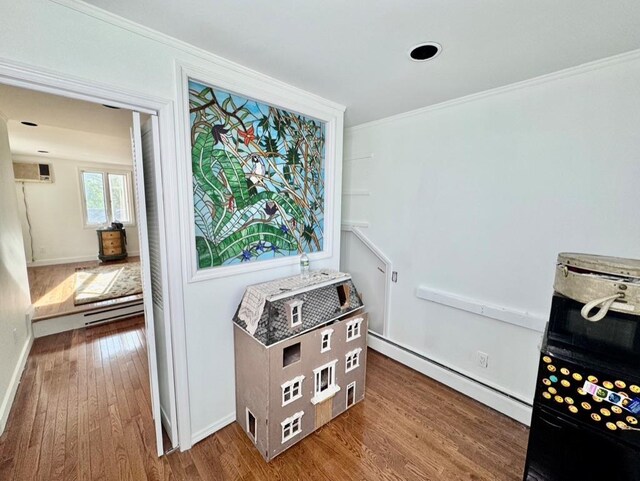 980 Siems Ct, North Bellmore, NY 11710 - detailed view of ornamental molding, a baseboard heating unit, wood finished floors, and baseboards