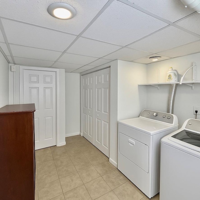 980 Siems Ct, North Bellmore, NY 11710 - laundry area with separate washer and dryer, light tile patterned floors, and baseboards
