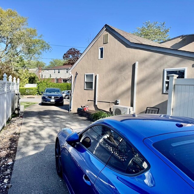 980 Siems Ct, North Bellmore, NY 11710 - view of side of home featuring stucco siding and fence