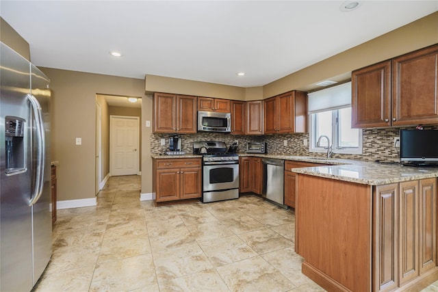 415 Spotswood Englishtown Rd, Nj, NJ 08831 - kitchen featuring appliances with stainless steel finishes, backsplash, light stone countertops, baseboards, and a peninsula