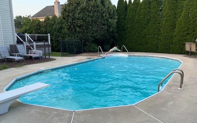 415 Spotswood Englishtown Rd, Nj, NJ 08831 - view of swimming pool with stairway, a wooden deck, a view of trees, and a patio area