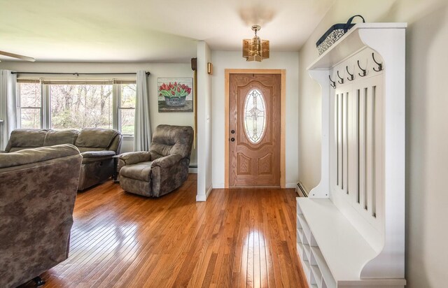 foyer featuring hardwood / wood-style flooring, baseboard heating, and baseboards