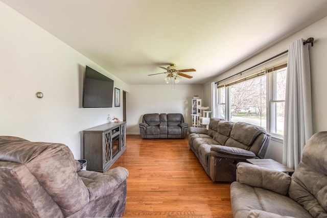 living room featuring ceiling fan and light wood-style floors