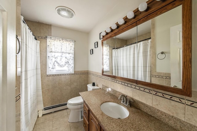 bathroom featuring a baseboard heating unit, tile walls, tile patterned flooring, toilet, and vanity