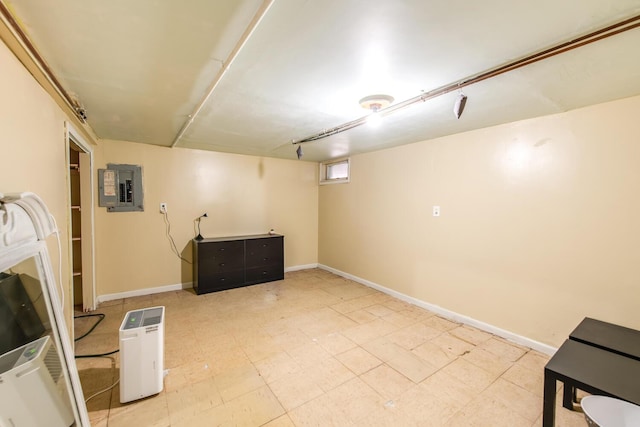 basement with electric panel and baseboards