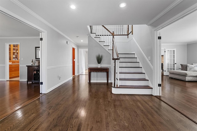 staircase featuring wood finished floors, recessed lighting, baseboards, and ornamental molding