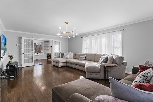 living room featuring crown molding, a chandelier, wood finished floors, french doors, and baseboards