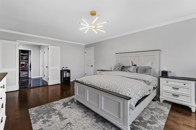 bedroom with dark wood-type flooring, crown molding, a chandelier, and baseboards