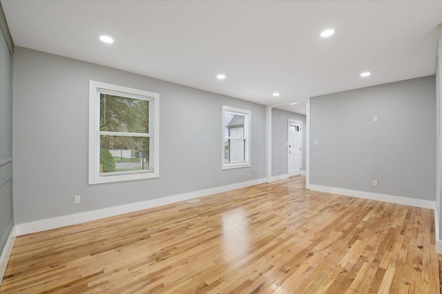 unfurnished living room featuring light wood finished floors, recessed lighting, and baseboards