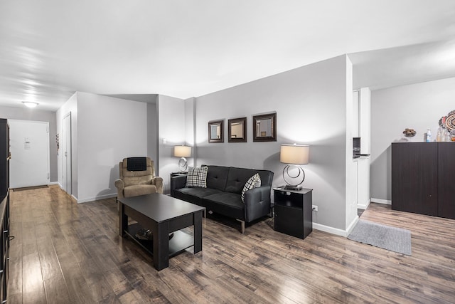 living room featuring wood finished floors and baseboards