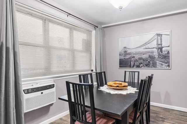 dining space with baseboards, wood finished floors, and cooling unit