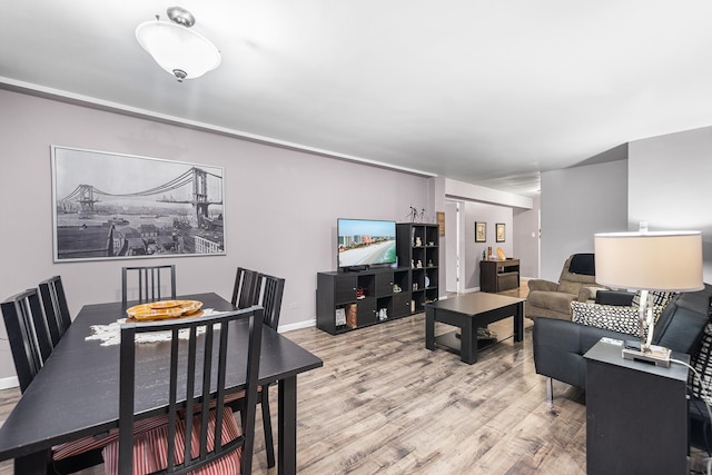 living area featuring light wood-style flooring and baseboards