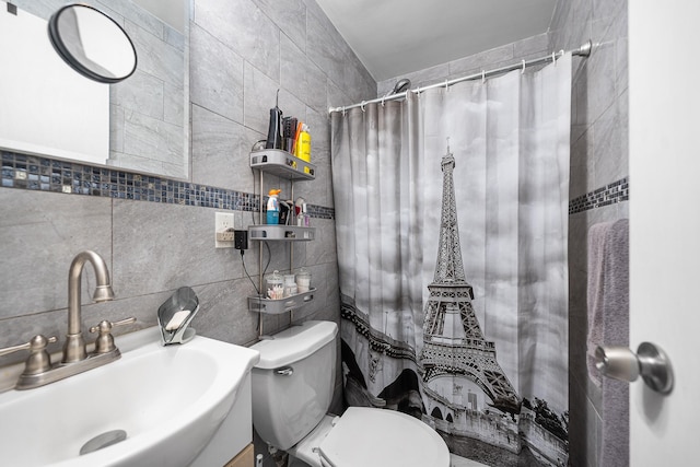 full bathroom with a sink, tile walls, toilet, and a shower with shower curtain