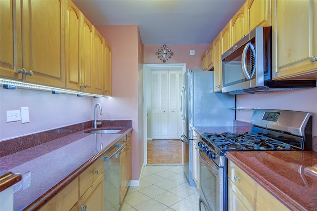 102-10 66th Rd Unit 26H, Forest Hills, NY 11375 - kitchen with stainless steel appliances, a sink, dark stone counters, and light tile patterned floors