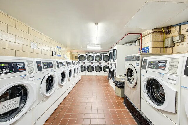 102-10 66th Rd Unit 26H, Forest Hills, NY 11375 - community laundry featuring washer and dryer and dark tile patterned floors
