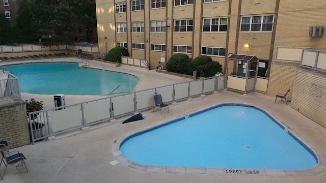 102-10 66th Rd Unit 26H, Forest Hills, NY 11375 - community pool featuring a patio and fence