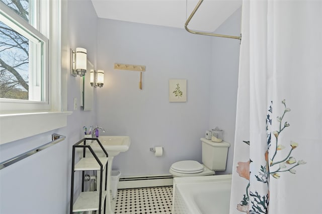 bathroom featuring baseboard heating, healthy amount of natural light, toilet, and a shower with curtain