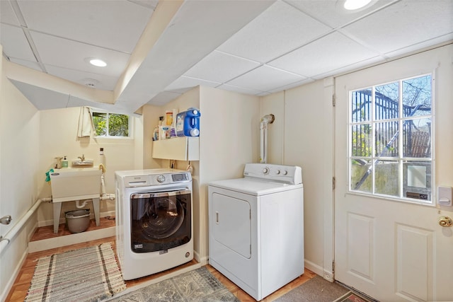 laundry room with washing machine and clothes dryer, baseboards, and recessed lighting