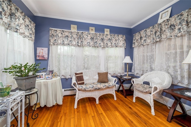 1875 Harte St, Baldwin, NY 11510 - living area featuring ornamental molding, wood finished floors, and a baseboard radiator