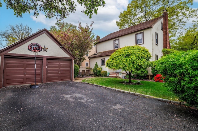 1875 Harte St, Baldwin, NY 11510 - view of front of property with a chimney, stucco siding, an outbuilding, and a front lawn