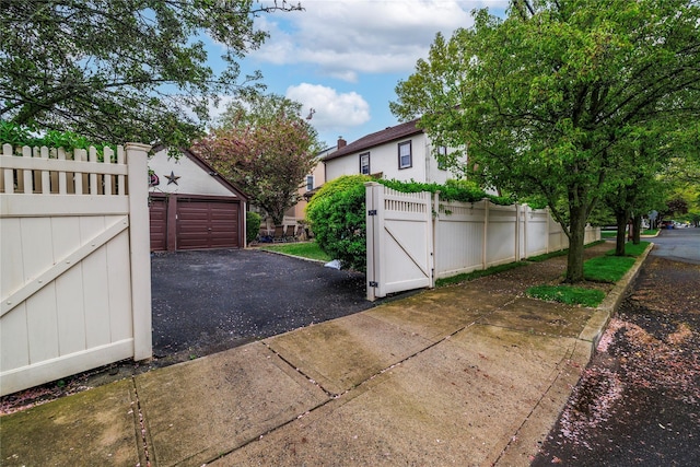 1875 Harte St, Baldwin, NY 11510 - garage with a gate, fence, and driveway