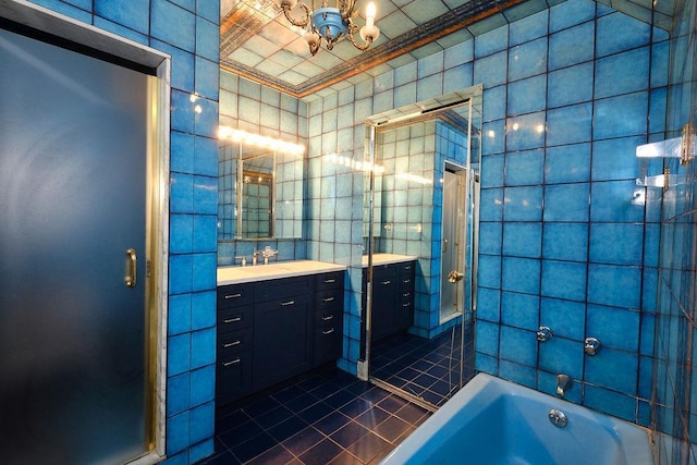21 Hereford Rd, Great Neck, NY 11020 - full bathroom featuring tile walls, tile patterned flooring, vanity, a chandelier, and a tub to relax in