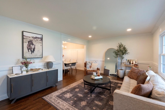 living room with arched walkways, dark wood-type flooring, crown molding, and recessed lighting