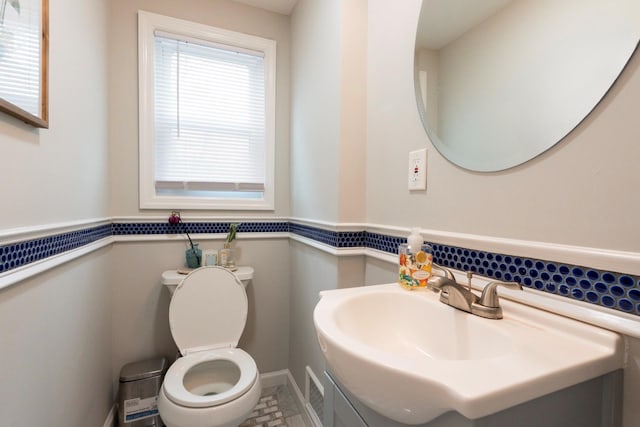 bathroom with toilet and baseboards
