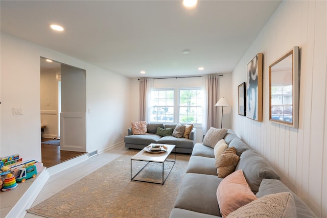 living room with tile patterned flooring and recessed lighting