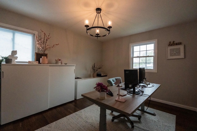 office space featuring wood finished floors and a chandelier