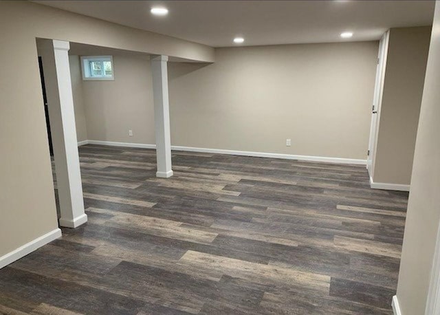 below grade area with baseboards, recessed lighting, and dark wood-type flooring