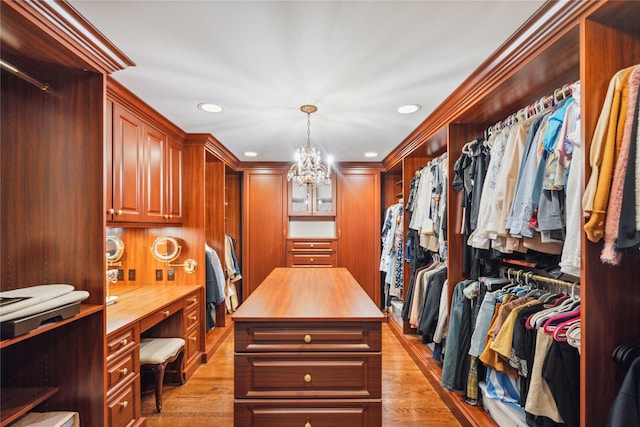 17 The Intervale, Roslyn Estates, NY 11576 - walk in closet with a chandelier, built in desk, and light wood-style flooring