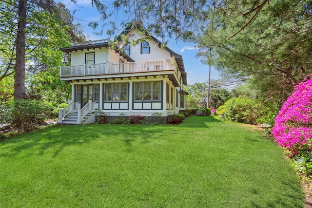 17 The Intervale, Roslyn Estates, NY 11576 - back of property featuring a balcony, a lawn, stucco siding, and a sunroom