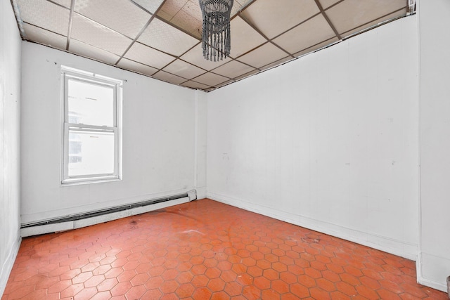 1410 Lincoln Pl, Brooklyn, NY 11213 - empty room with baseboard heating, a paneled ceiling, and baseboards
