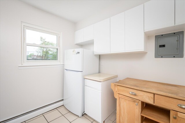 washroom with baseboard heating, electric panel, and light tile patterned floors