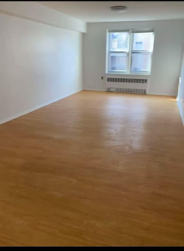 42-40 Bowne St Unit 3L, Flushing, NY 11355 - empty room featuring radiator and wood finished floors