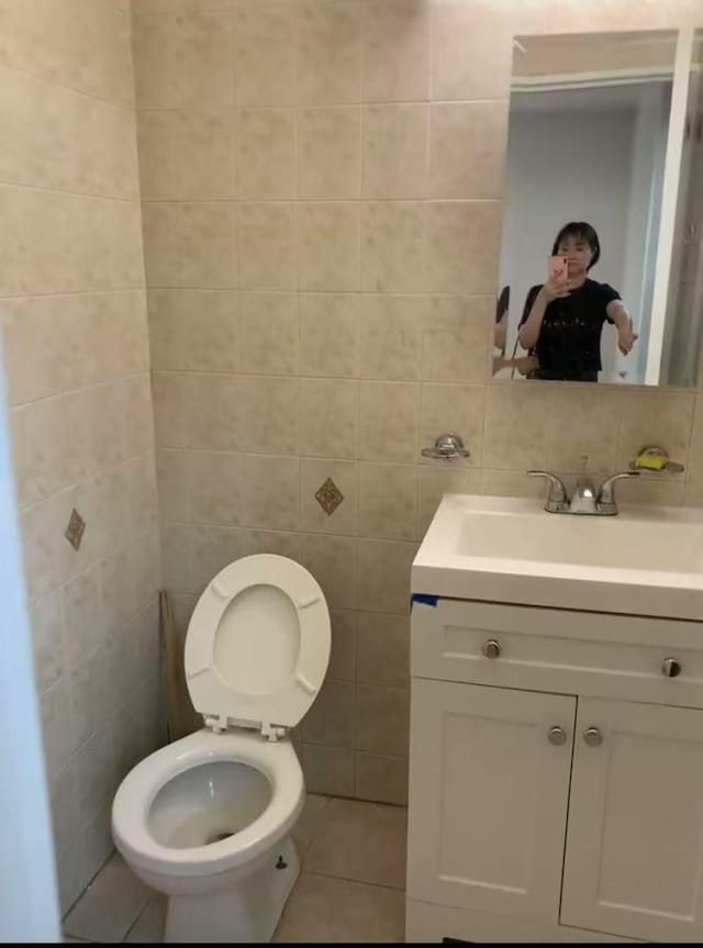 42-40 Bowne St Unit 3L, Flushing, NY 11355 - bathroom with tile walls, vanity, toilet, and tile patterned floors
