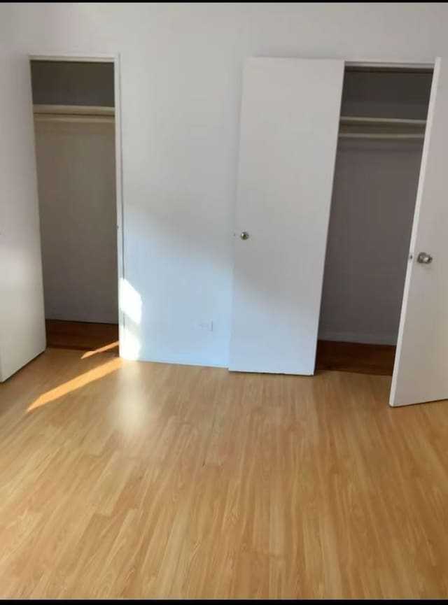 42-40 Bowne St Unit 3L, Flushing, NY 11355 - unfurnished bedroom featuring light wood finished floors