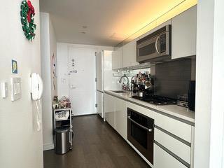 kitchen with black appliances, a sink, light countertops, and white cabinets
