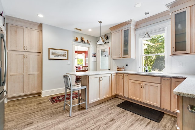 4 Oak St, Cold Spring, NY 10516 - kitchen featuring light brown cabinetry, a peninsula, a sink, light wood-style floors, and recessed lighting