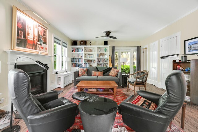 4 Oak St, Cold Spring, NY 10516 - living area with wood finished floors, a glass covered fireplace, a ceiling fan, and crown molding