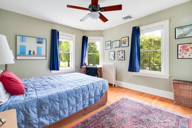 4 Oak St, Cold Spring, NY 10516 - bedroom with radiator, wood finished floors, baseboards, and a ceiling fan