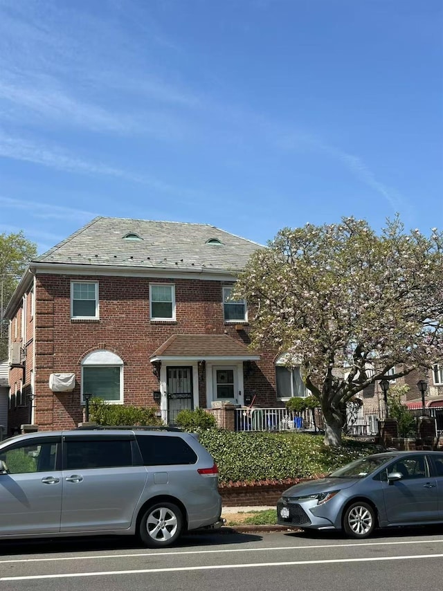 townhome / multi-family property featuring brick siding and a high end roof