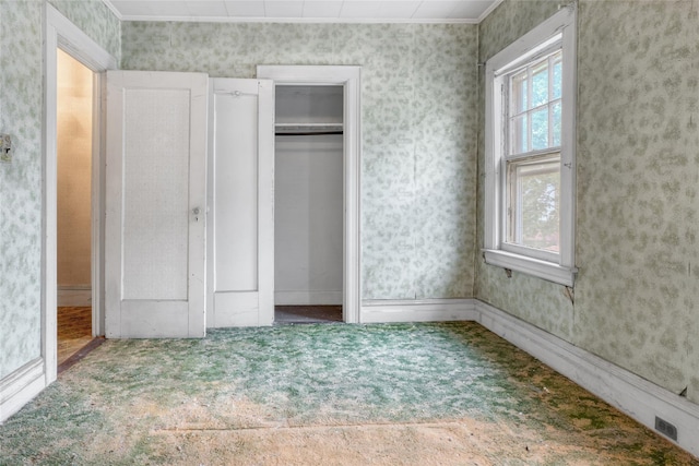 1804 New York Ave, Brooklyn, NY 11210 - unfurnished bedroom featuring wallpapered walls, carpet, a closet, and crown molding