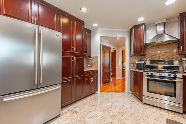 kitchen featuring appliances with stainless steel finishes, wall chimney range hood, tasteful backsplash, crown molding, and reddish brown cabinets