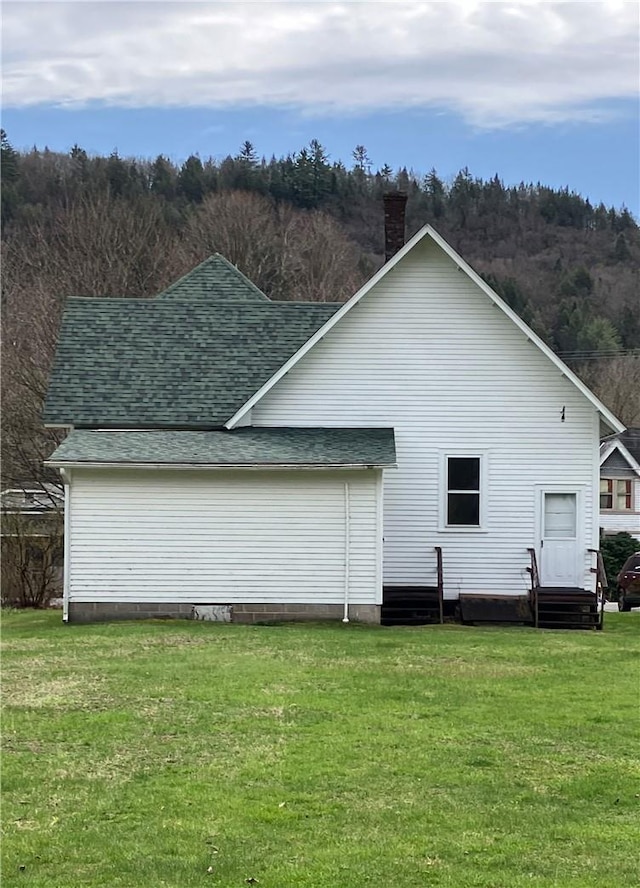 14 Hankins Rd, Hankins, NY 12741 - back of property featuring roof with shingles, a chimney, and a yard